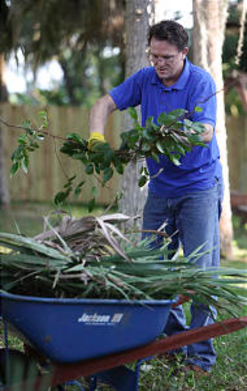 Kevin Landress of the Cocoa Florida Stake clears yard trash at Resurrection Ranch, a shelter for hom