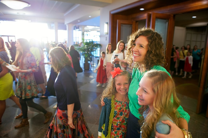 A mother and her two daughters exit the Conference Center after attending the general women’s session.
