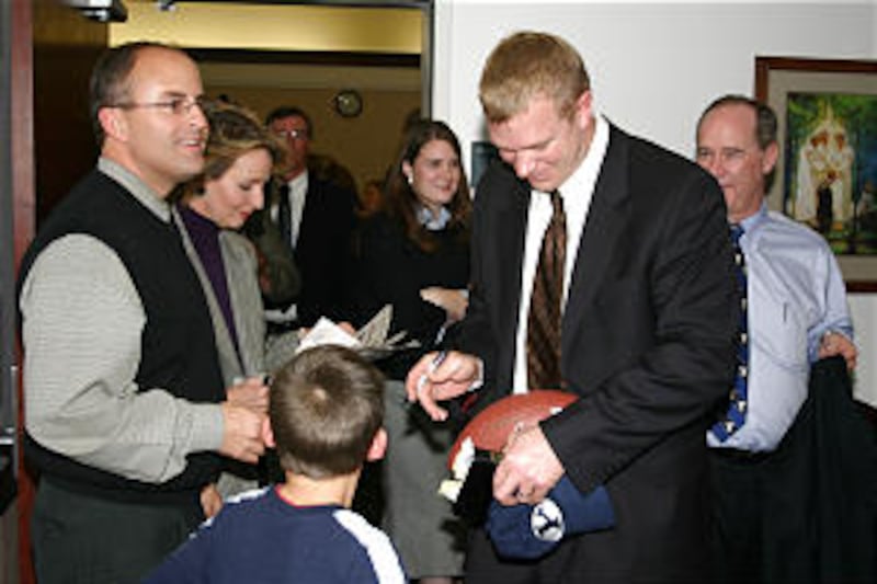 Coach Bronco Mendenhall signs autograph following fireside.