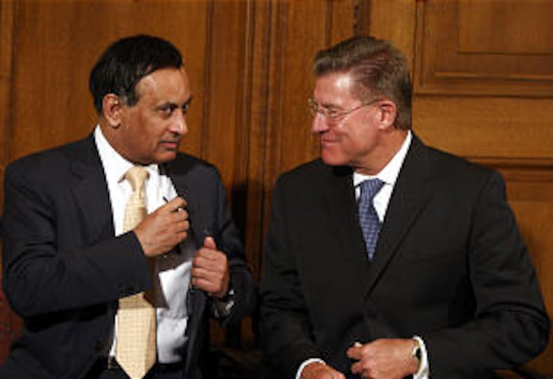 Pakistani ambassador Husain Haqqani, left, talks with, Lynn Samsel, Director of Humanitarian Service