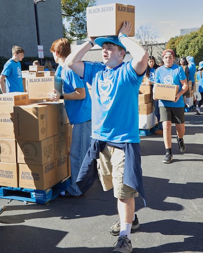 Joseph Gleason, a JustServe youth volunteer, helps move boxes from an America250 food donation from The Church of Jesus Christ of Latter-day Saints onto pallets for delivery to almost a dozen different charities in the Irvine, California, area on Saturday, Feb. 21, 2026.