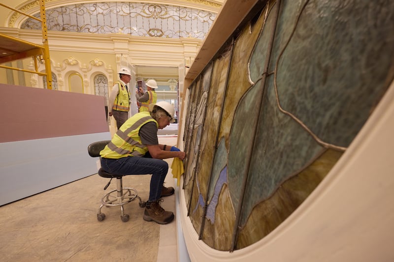 During installation, a worker cleans an art-glass piece featuring Adam and Eve on Tuesday, April 21, 2026, in Salt Lake City. The artwork will be in the celestial room of the Salt Lake Temple.