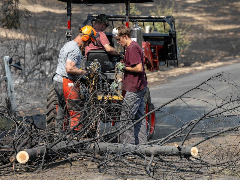 Young men and leaders from the Spokane Washington Mount Spokane Stake help clear debris from a neighborhood damaged by wildfires in Spokane, Washington, on Monday, Aug. 3, 2026.