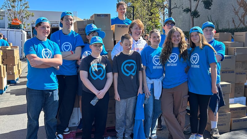 Sharon Eubank, the Church's Humanitarian Services director, middle, poses with youth JustServe volunteers on Saturday, Feb. 21, 2026, at the South County Outreach in Irvine, California, after an America 50 food donation from the Church.