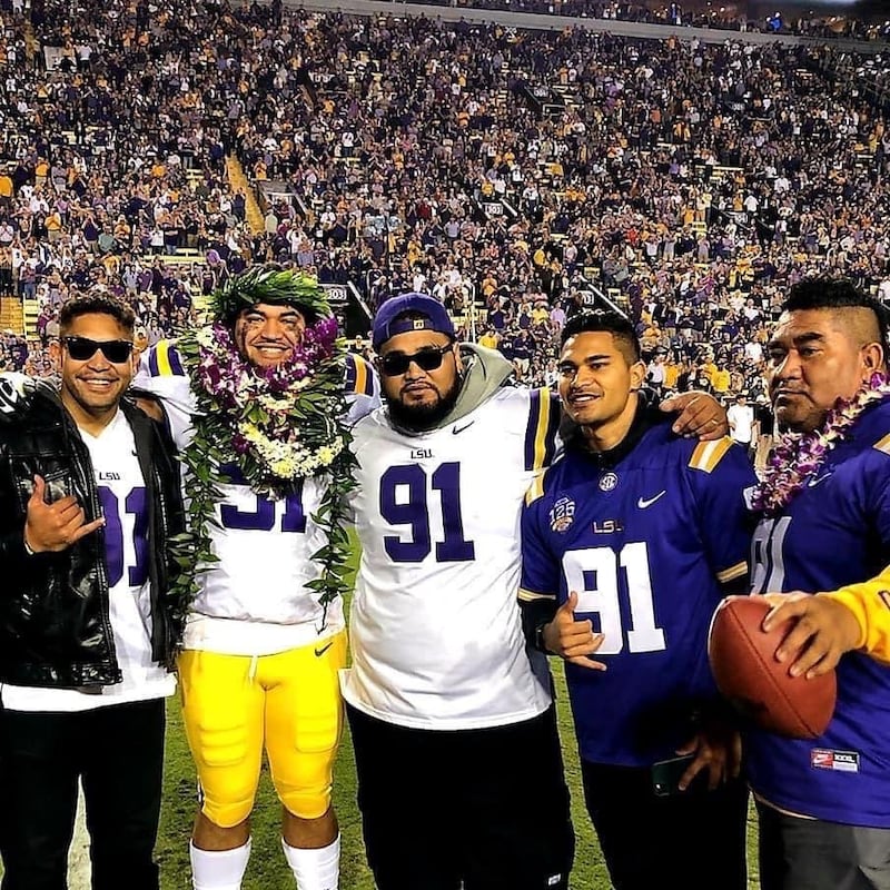 Breiden Fehoko, second from the left, with his father and brothers on senior night at LSU in 2019.