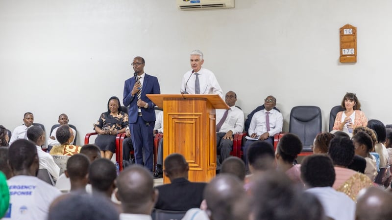 Elder Gérald Caussé speaks at a pulpit to members during his visit to Bujumbura, Burundi, Oct. 21, 2026.