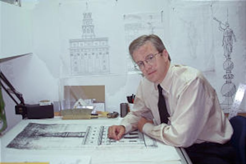 With new drawing on wall and copy of original on his desk, Roger P. Jackson shows design work.
