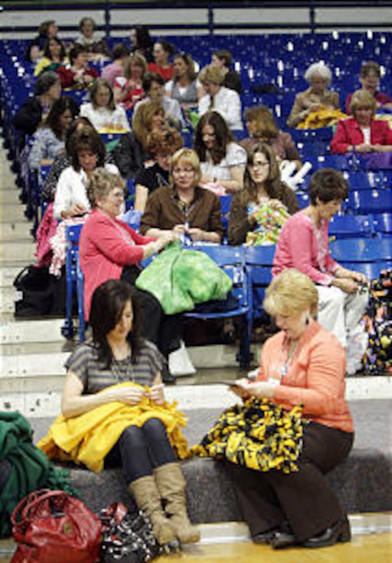 Women volunteers tie fleece blankets during Women's Conference evening of service at BYU on April 2
