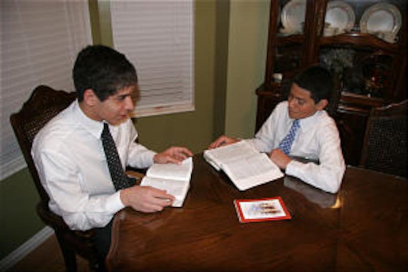 James Rice, left, a priest from South Jordan, Utah, studies the scriptures with younger brother, Mar