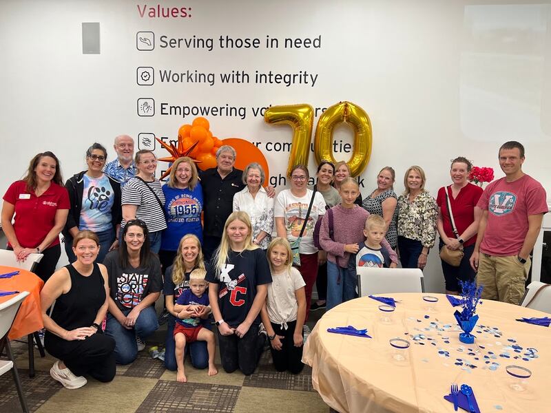Friends and family members of Gwynne Fullmer smile for a photo while volunteering at Midwest Food Bank in Gilbert, Arizona, on Oct. 18, 2025, to celebrate Fullmer's 70th birthday.
