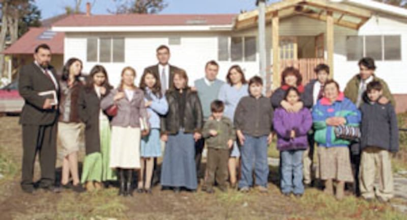 Bundled against the cold, families gather in front of new Puerto Williams Branch meetinghouse. This,