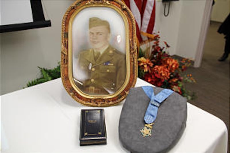 Medal of Honor awarded to Leonard Brostrom, an LDS soldier in World War II, is displayed with his fr
