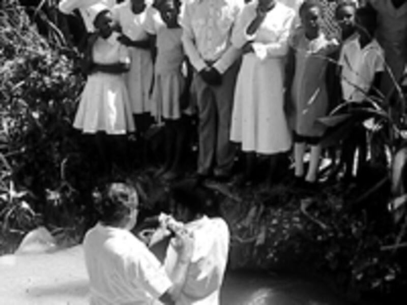 Alexandre Mourra baptizes one of 22 new members on July 2, 1978.
