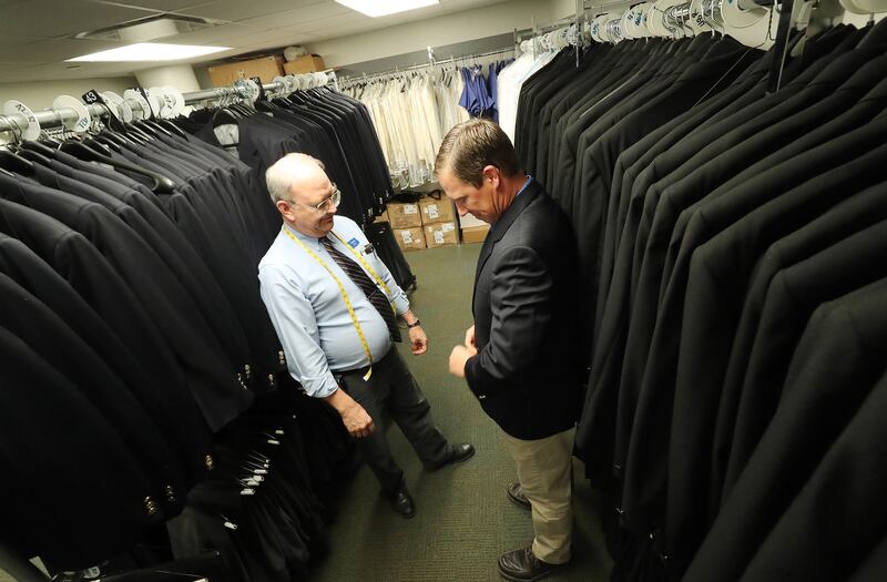 Daniel Wilson, right, gets fitted with a suit by Vance Everett in preparation to sing with The Tabernacle Choir at Temple Square during a rehearsal in Salt Lake City on Thursday, April 11, 2019. Four people were selected through social media to sing with the choir.