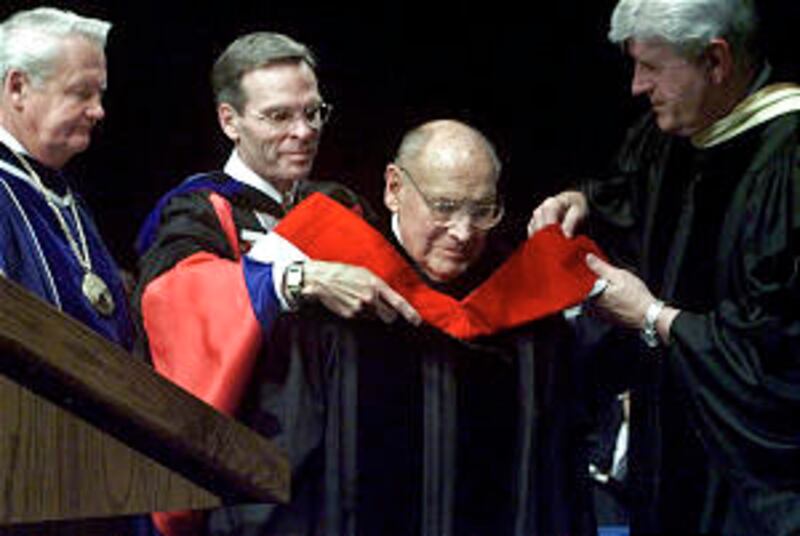 Elder Joseph B. Worthlin is hooded for a Honorary Doctoral Degree at BYU Graduation. PHOTO BY STUAR