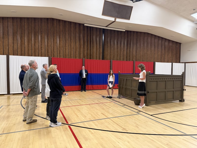 Two Latter-day Saint young women explain about the altar of sacrifice to a group of visitors in the tabernacle courtyard replica in the Farmington Utah North Stake, June 18, 2026.
