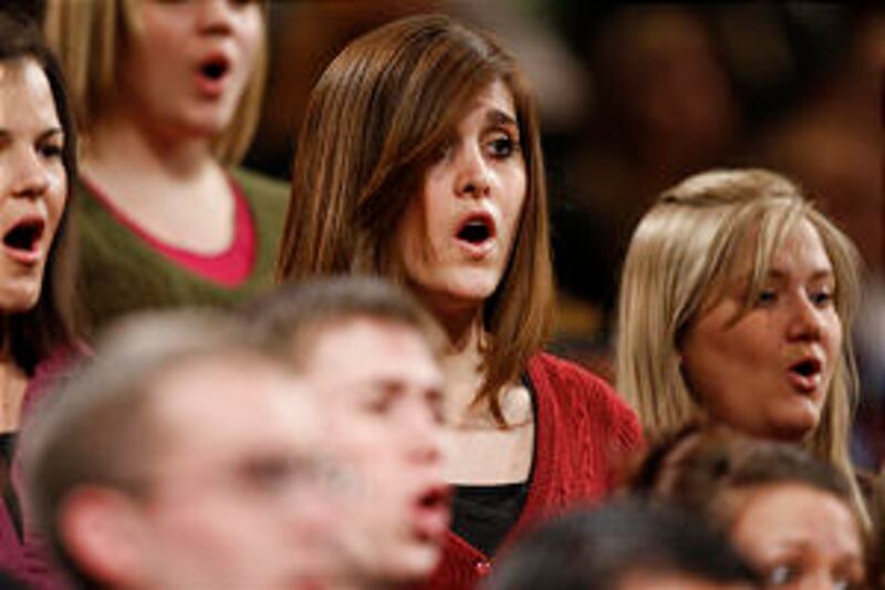 A choir from both BYU and the University of Utah sing at a CES Fireside where Elder Robert D. Hales