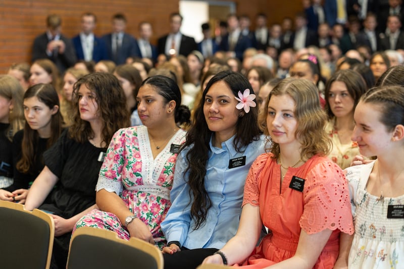 Sister missionaries of The Church of Jesus Christ of Latter-day Saints await the arrival of Elder Gérald Caussé of the Quorum of the Twelve Apostles and his wife, Valérie, at the Paris France Stake Center in Versailles on Friday, Feb. 27, 2026.