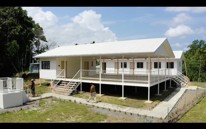 A simplified meetinghouse in Papua New Guinea equipped with solar panels and satellite internet enables congregations to gather, study and participate in Church programs in remote areas.