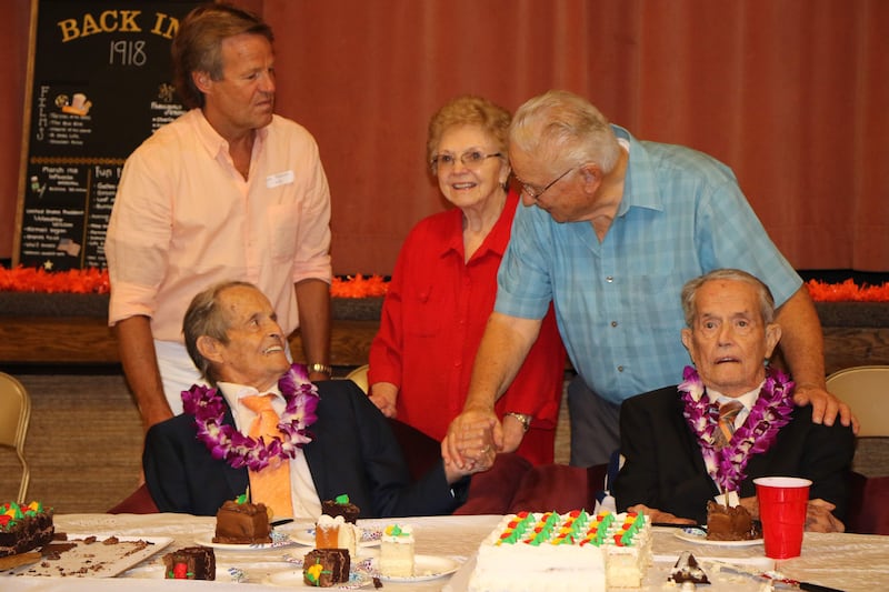 Twin brothers Ralph and Boyd Henderson visit with family and friends at their 100th birthday party last week in Pocatello, Idaho.