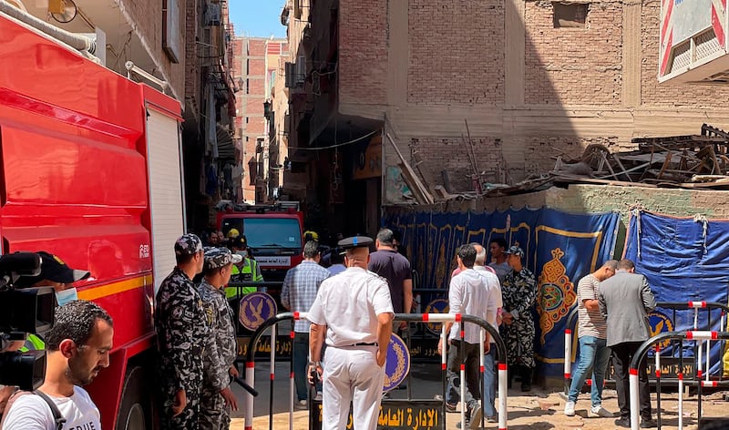 Emergency personnel work at the site of a fire at the Abu Sifin church that has killed over 40 people and injured at least 14 others.