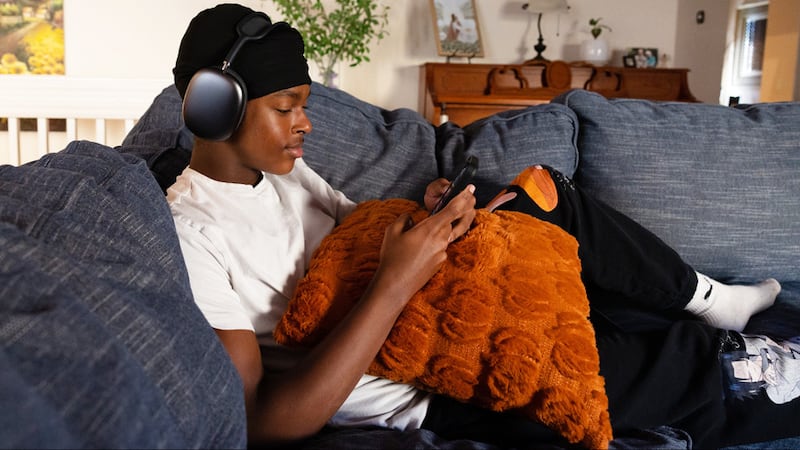 A man listens to music while using new Gospel Library music features.