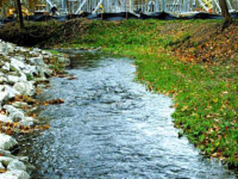 Above, branch of Chagrin River meanders past new visitors center which is being constructed to resem