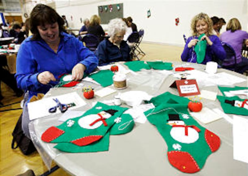 Doralee Gull, Las Vegas, Beverley Little, Syracuse, and Tamara Littel, Springville, sew Christmas s