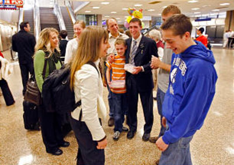Breanne Hawkins sizes up her little brother, Jordan, as she returns home from her mission Wednesday