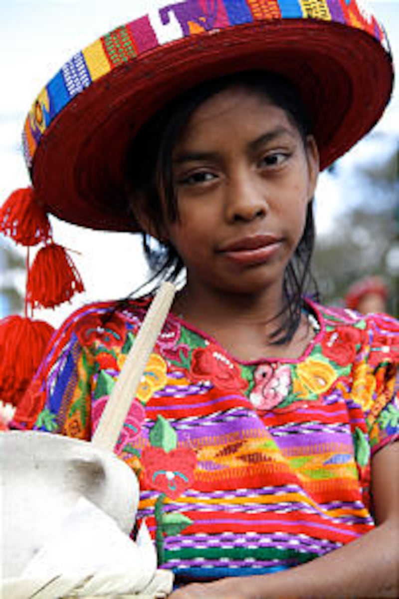 A young girl in traditional dress waits to dance for President Dieter F. Uchtdorf and the other visi