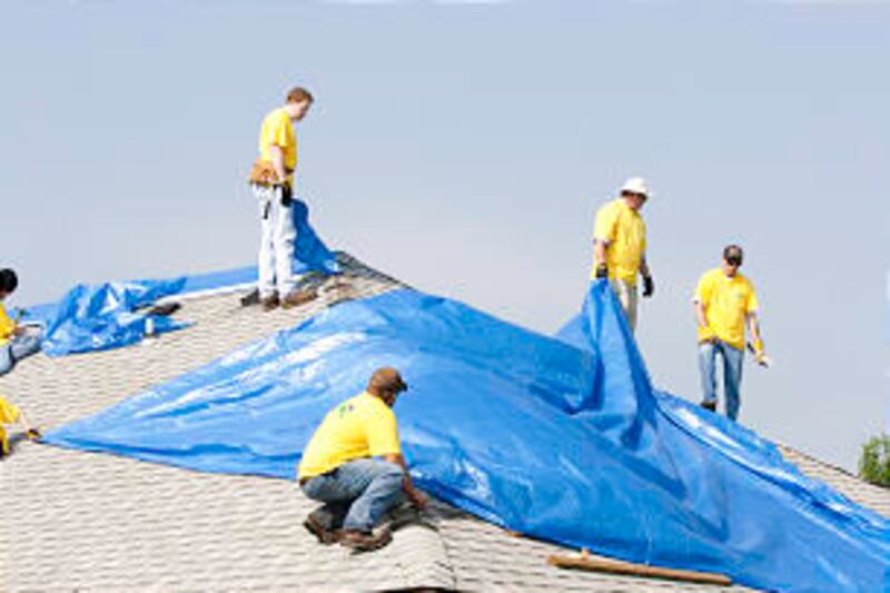 Tarps are placed on damaged house to protect it from elements. More than 25 percent of Joplin, inclu