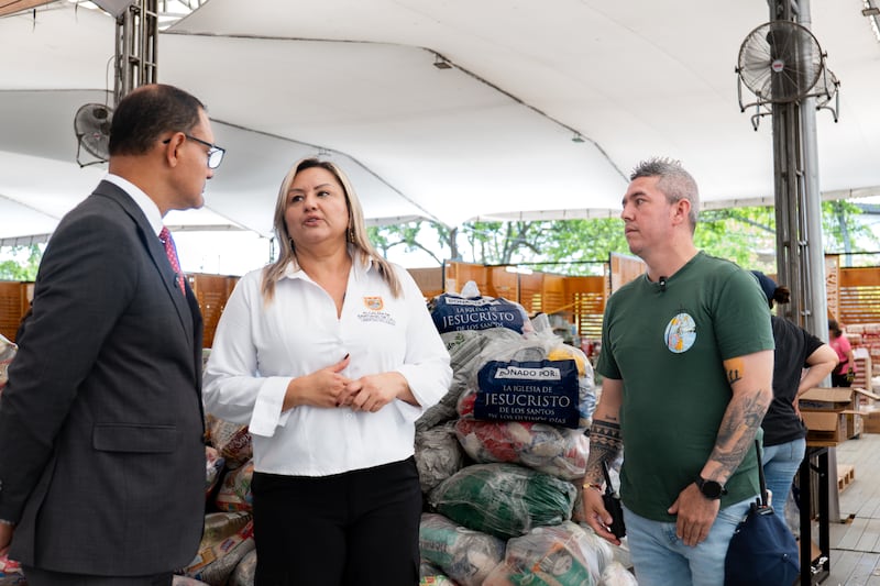Elder Harold Truque, an Area Seventy from Cali, Colombia, left; speaks with Natalia Lasso, advisor to the Cali Mayor’s Office, center; at a main collection center to distribute 1,000 food kits to various areas affected by an earthquake in Cali, Colombia, in August 2026.