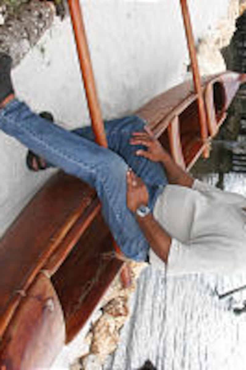 President F. Sitiveni Fehoko of the Nuku'alofa Tonga Stake sits in hand-made canoe in Old Tonga vill