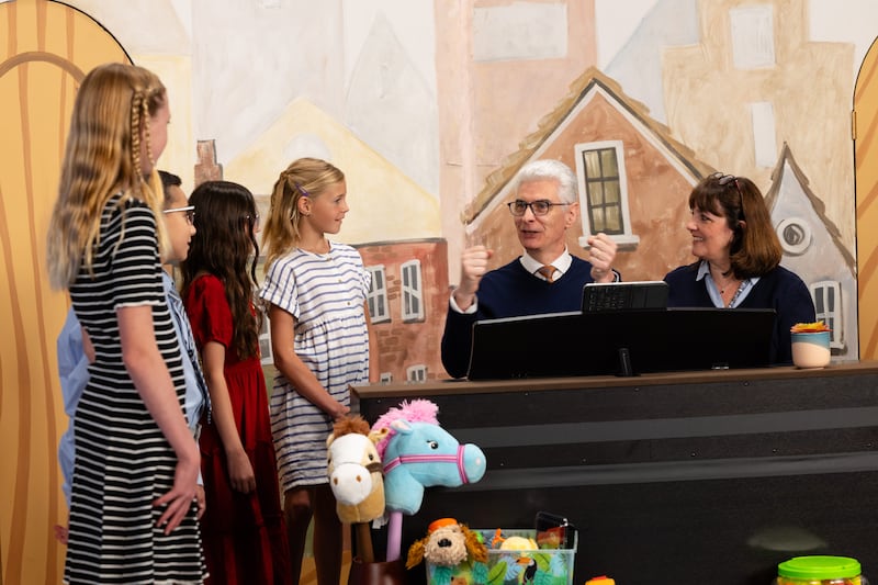Elder Gérald Caussé of the Quorum of the Twelve Apostles and his wife, Sister Valérie Caussé, prepare to sing with a group of children during the September 2026 Friend to Friend broadcast.