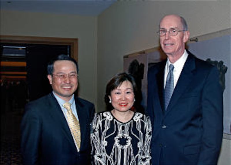 President Eyring poses with Kyou-hyun Kim, a political minister, and his wife, Selee Kim, at the BYU