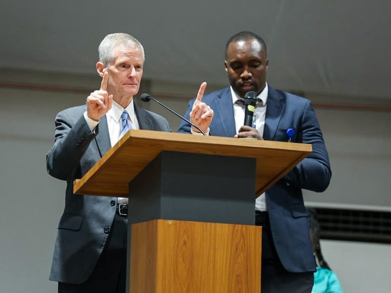 Elder David A. Bednar speaks at the pulpit next to a translator during a devotional in Kigali, Rwanda, March 17, 2026.