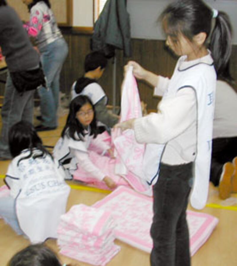 Children in Hong Kong help assemble some 10,000 kits that were later distributed in Sri Lanka.