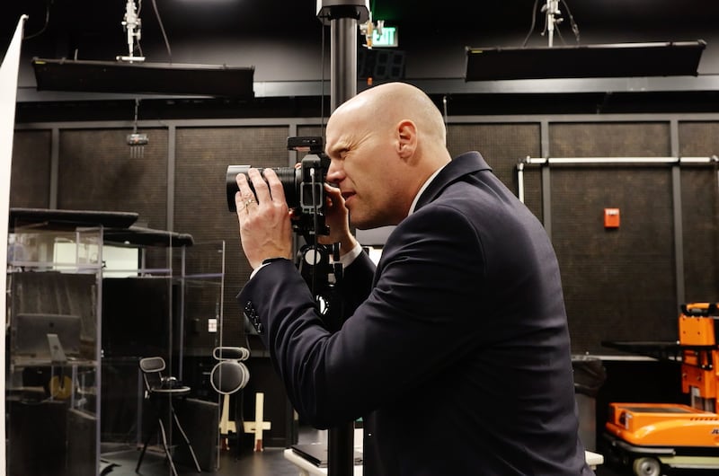 Church photographer Cody Bell takes a picture at a studio in the Church Office Building in Salt Lake City, Utah.