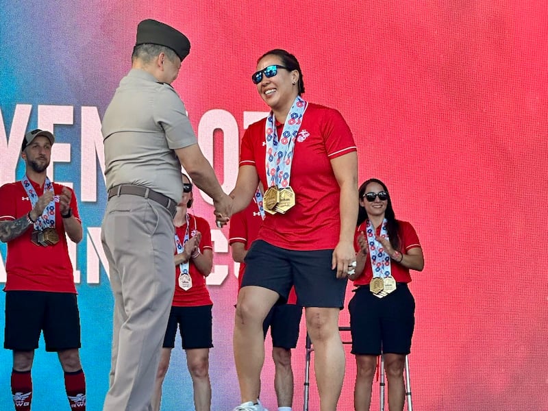 Retired U.S. Marine Maj. Yen Soto is awarded four gold medals following the swimming competition at the 2025 Warrior Games in Colorado Springs, Colorado.