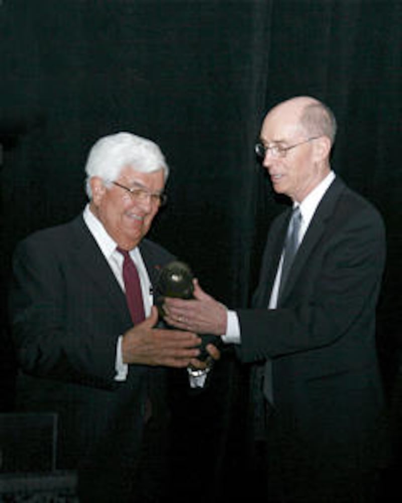 Tom Korologos, former U.S. ambassador to Belgium, presents President Eyring with the BYU Management