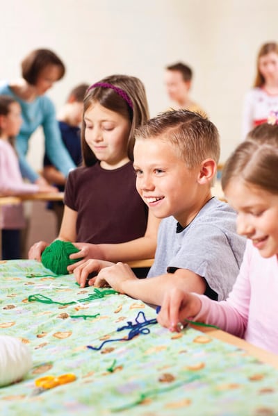 Children quilt together. Children are invited to participate in #LightTheWorld this year with their own calendar of daily service ideas.