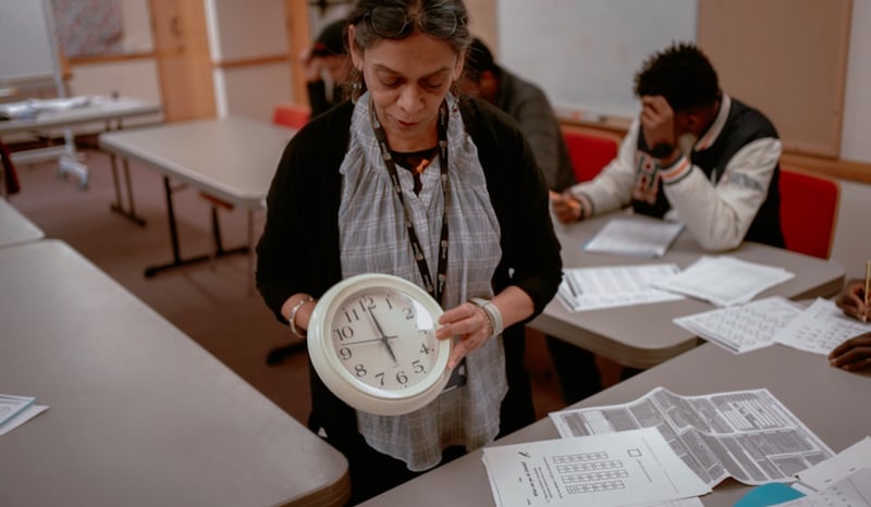 An instructor teaches about time during an English as a Second Language held at the Wembley Friendship and Outreach Center.