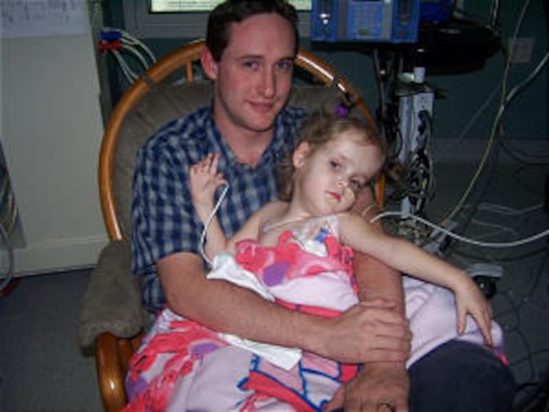 Jake Herrin holds daughter Maliyah on Aug. 25, separate for the first time from her twin sister Kend