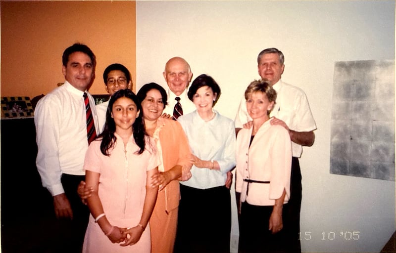 In an October 2005 photo, then-Elder Dallin H. Oaks and Sister Kristen M. Oaks, center, pause for a photo with Rodrigo and Alessandra Myrrha and their children, left.