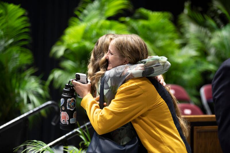 Sister Monica Kauwe greets a student following a devotional in the Cannon Activities Center in Laie, Hawaii, on Tuesday, May 3, 2022.