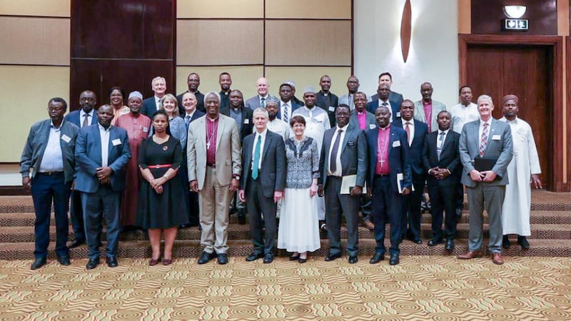 Elder David A. Bednar and Sister Susan Bednar take a picture with about 30 members of the Rwanda Interfaith Council in Rwanda on March 16, 2026.