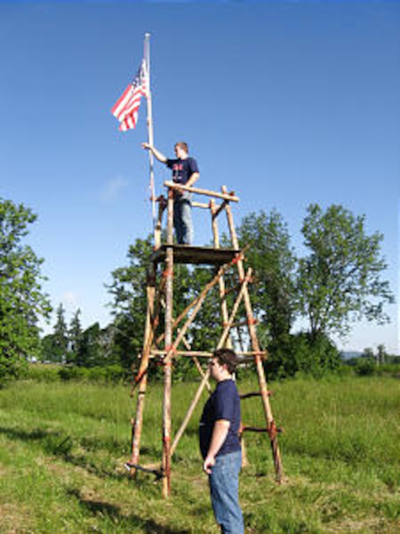 Craig Richins directs a camp activity atop a tower. Eagle Scouts who stay active in Scouting often e