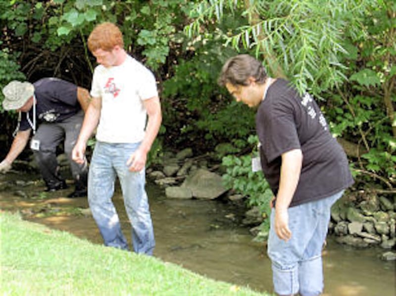 Stake Young Men's President Raul Kemp, left, leads a landscaping project at the Columbus Ohio Temple