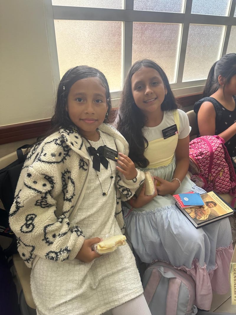 Maite Luis, left, and Lia Guiracocha Mendoza wear "future missionary" tags and smile for a photo during the Samborondón Ecuador Stake Primary's mini missionary training center activity in Guayaquil, Ecuador, Feb. 21, 2026.
