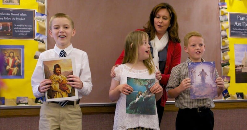 Children and a Primary teacher participate in singing time.